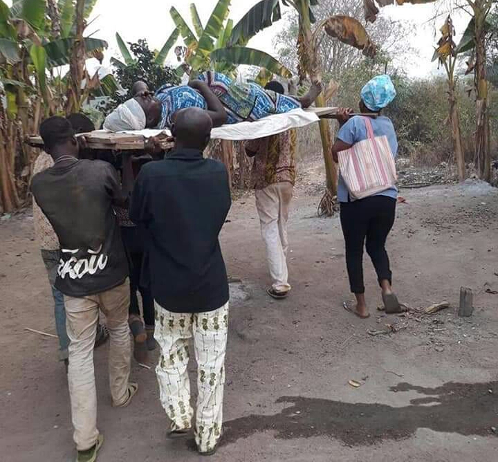 Midwife, Others Carry Pregnant Woman In Labour On Wooden Stretcher