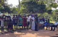 Residents Queue for MP's Fee-Paying, Clothing, and Shoes