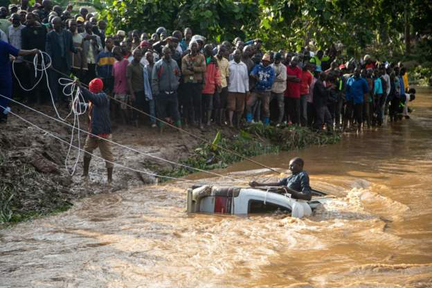 Ugandan Villagers Pull Submerged Minibus from River